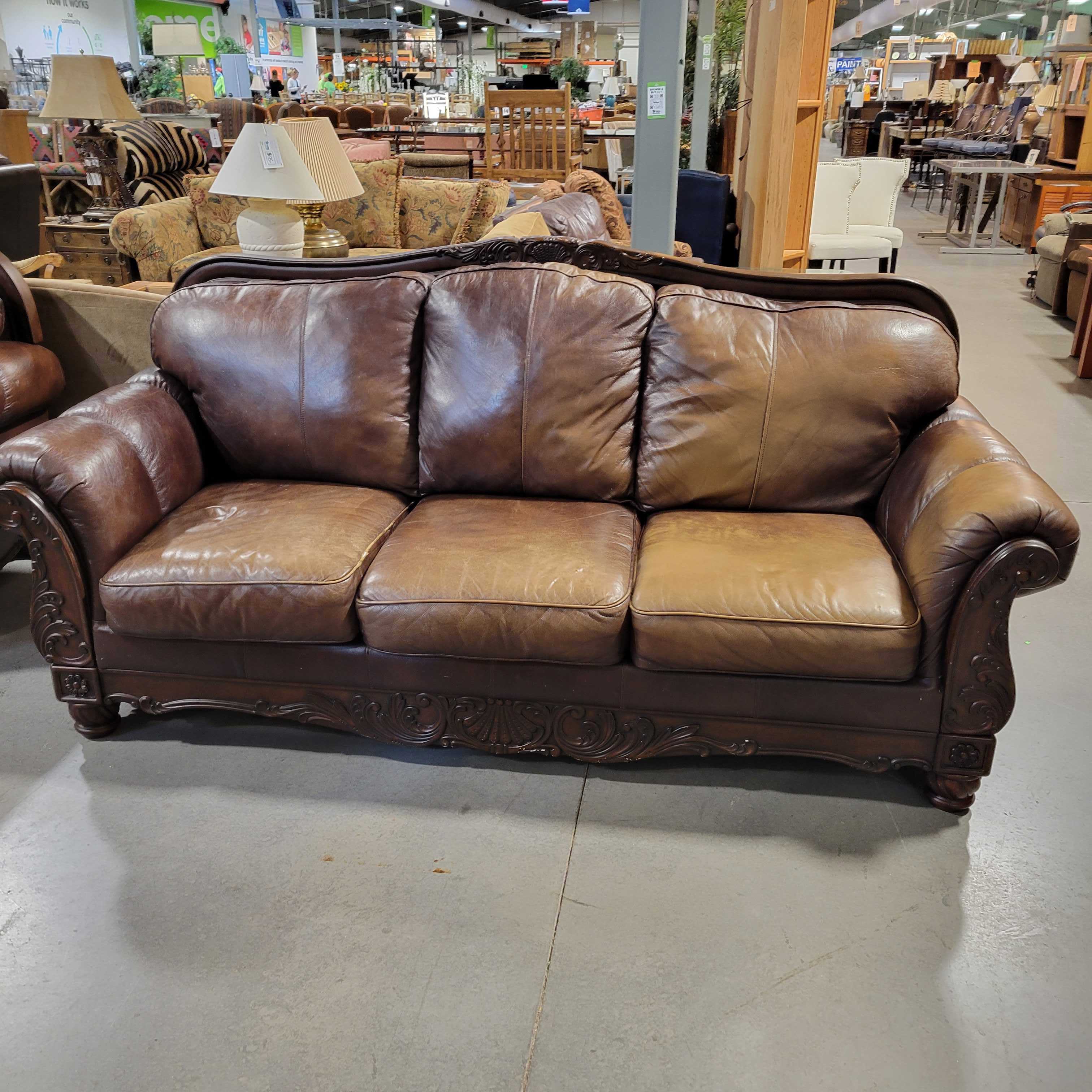 Ashley Furniture Carved Wood & Brown Leather Sofa