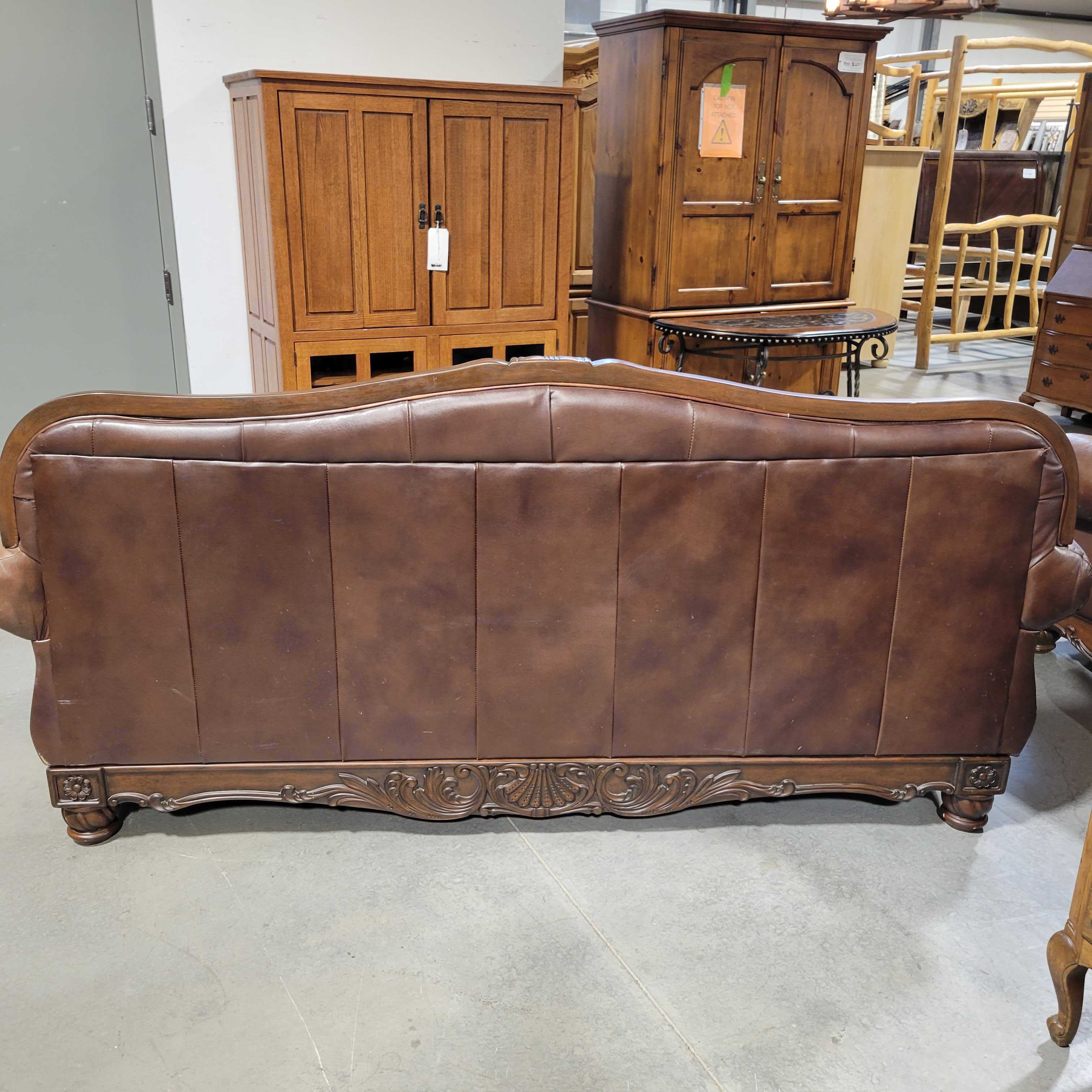 Ashley Furniture Carved Wood & Brown Leather Sofa