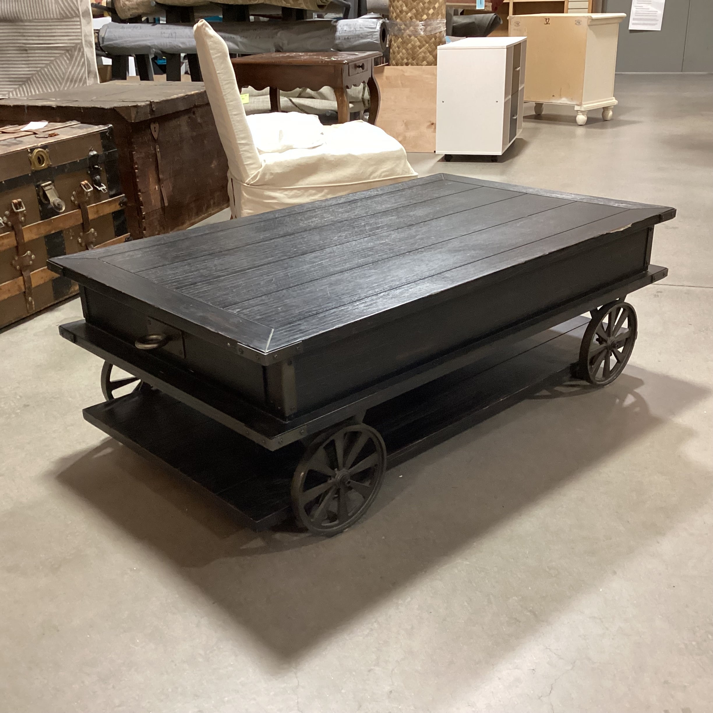 Magnussen Home Sheffield Antiqued Black Wood 2 Drawer with Wheels Cart Like Coffee Table 50"x 30"x 17.5"