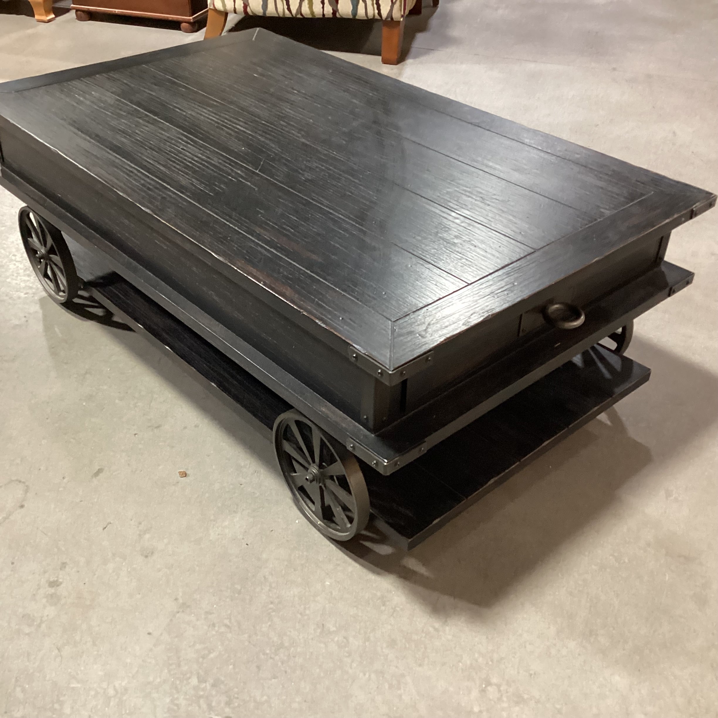 Magnussen Home Sheffield Antiqued Black Wood 2 Drawer with Wheels Cart Like Coffee Table 50"x 30"x 17.5"