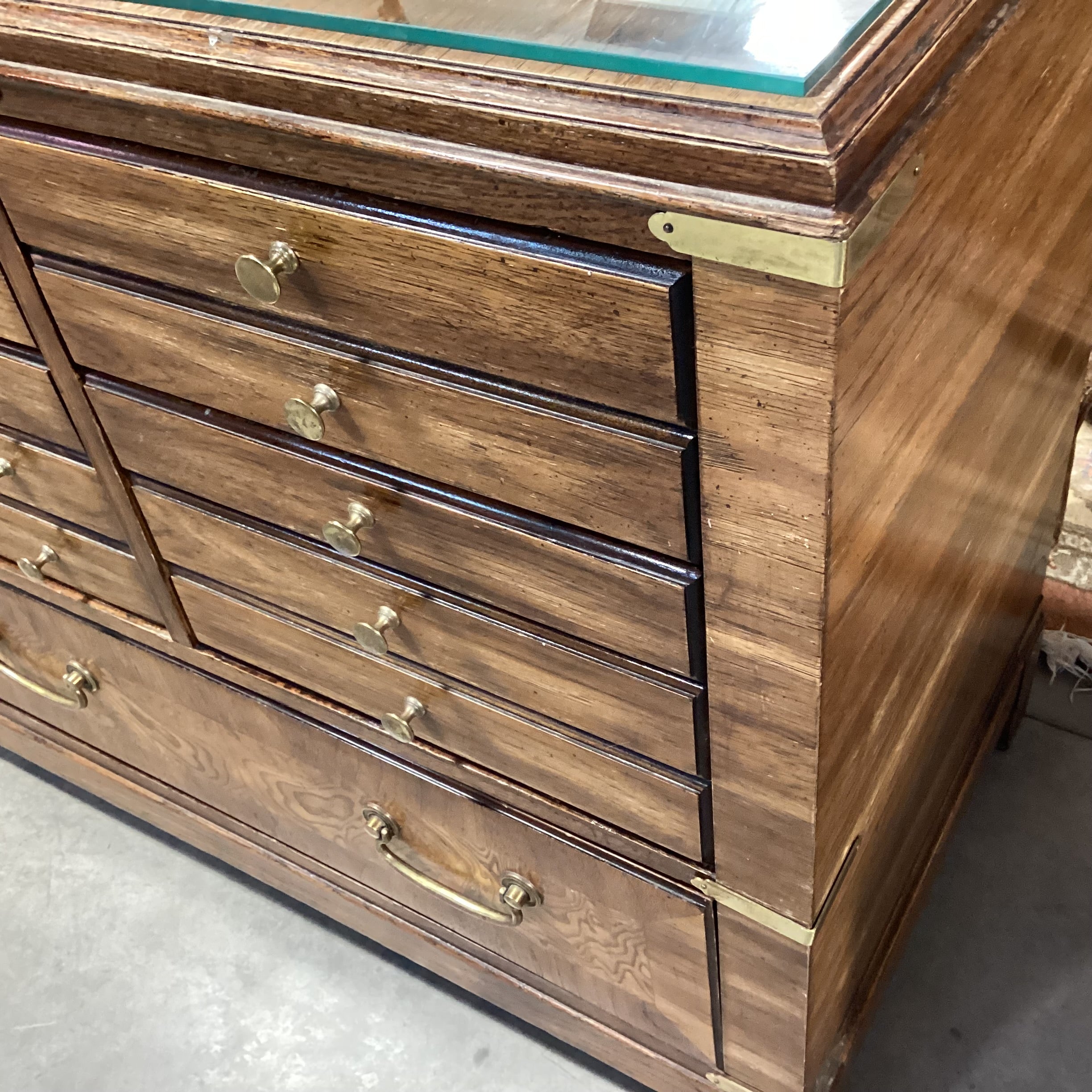 Vintage Lane Campaign Style Wood & Burl Veneer 8 Drawer with Brass Accent & Glass Top Dresser 64"x 19"x 30"
