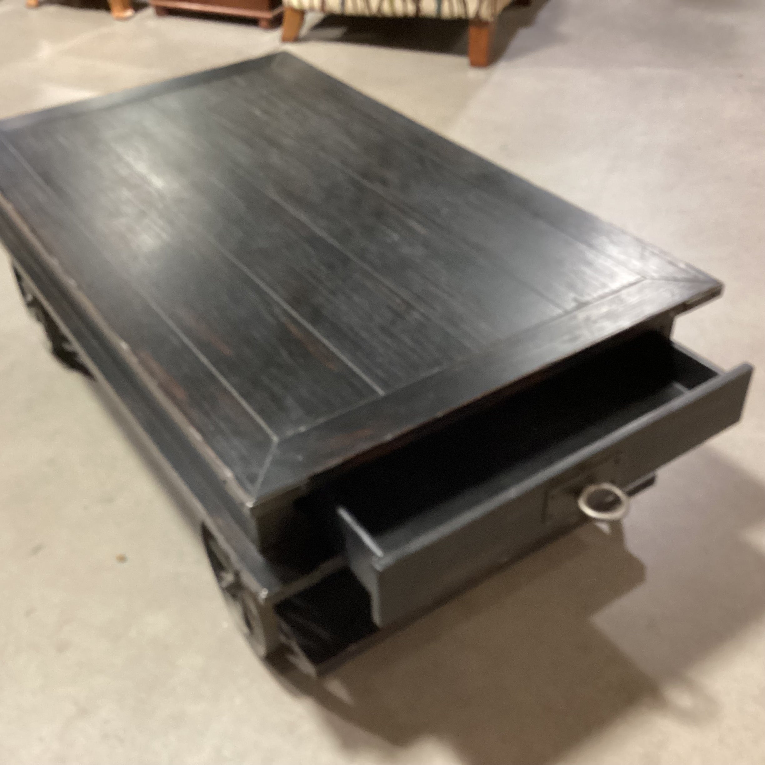 Magnussen Home Sheffield Antiqued Black Wood 2 Drawer with Wheels Cart Like Coffee Table 50"x 30"x 17.5"