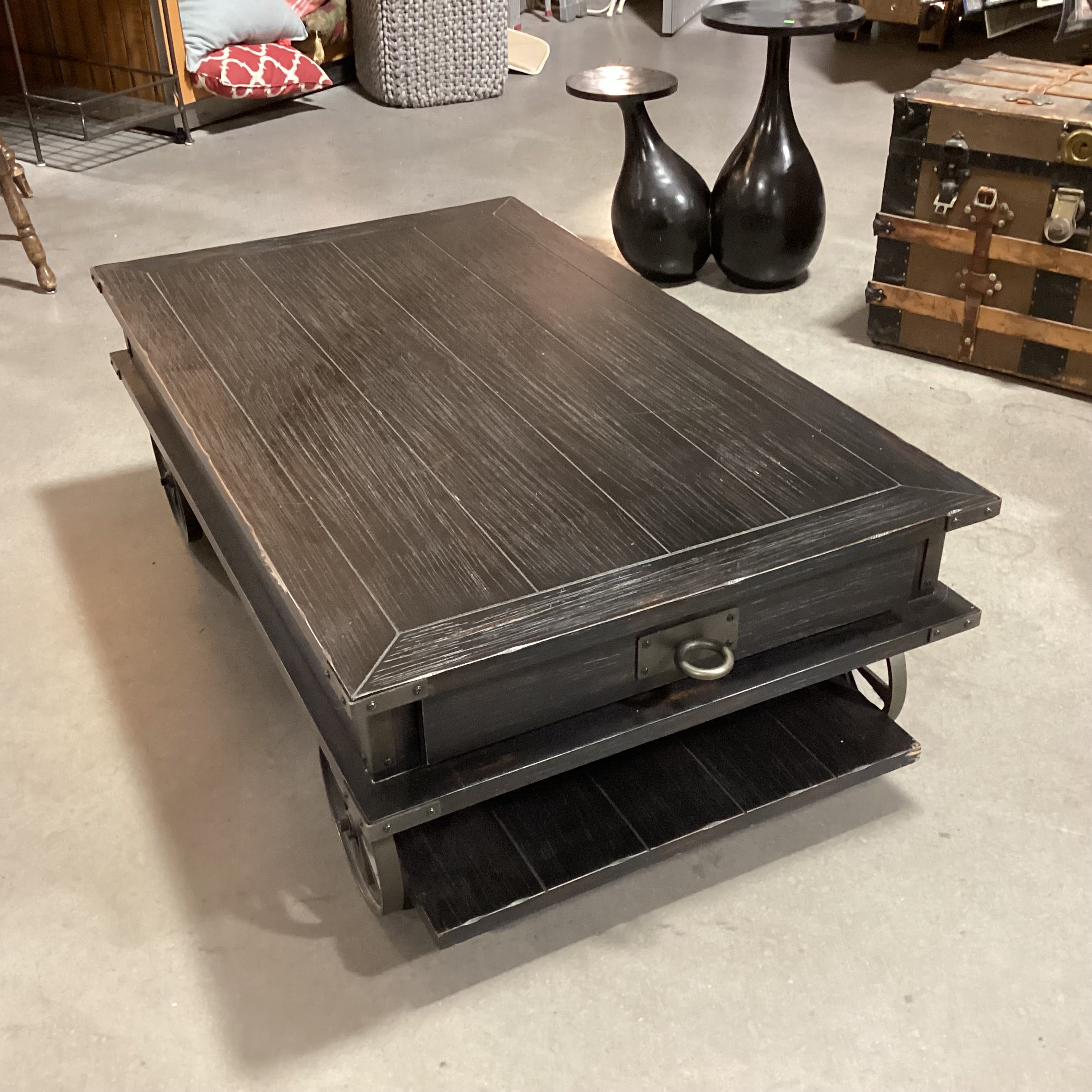 Magnussen Home Sheffield Antiqued Black Wood 2 Drawer with Wheels Cart Like Coffee Table 50"x 30"x 17.5"