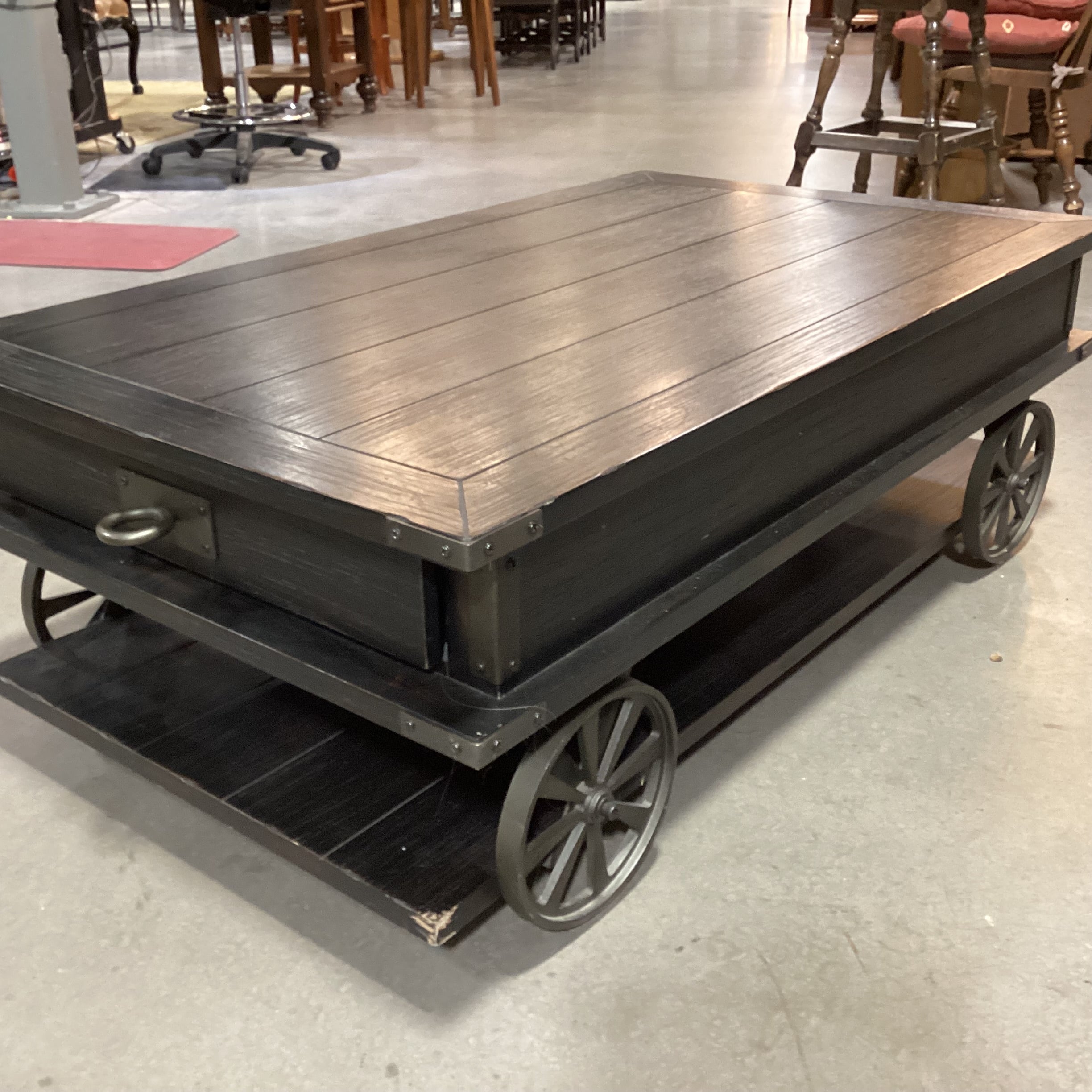 Magnussen Home Sheffield Antiqued Black Wood 2 Drawer with Wheels Cart Like Coffee Table 50"x 30"x 17.5"